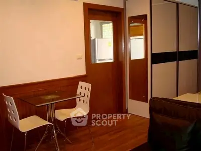 Modern apartment interior with dining area and kitchen view