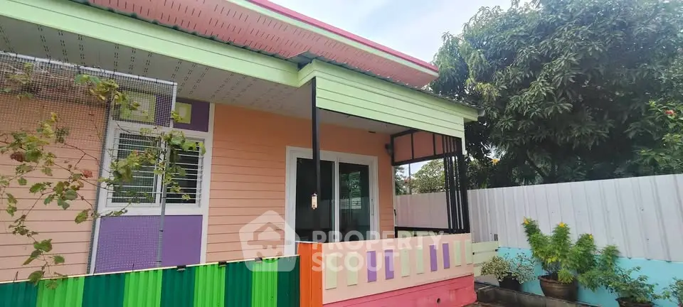 Charming colorful house exterior with vibrant accents and lush greenery.