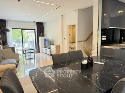 Spacious modern living room with elegant dining area and balcony view