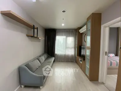 Modern living room with sleek design, featuring a comfortable sofa, wall-mounted shelves, and a large window.