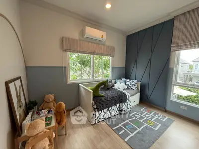 Charming children's bedroom with playful decor and large window view.