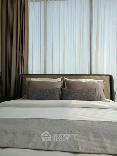 Luxurious bedroom with elegant bedding and floor-to-ceiling windows