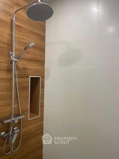 Modern bathroom with sleek shower and wood paneling