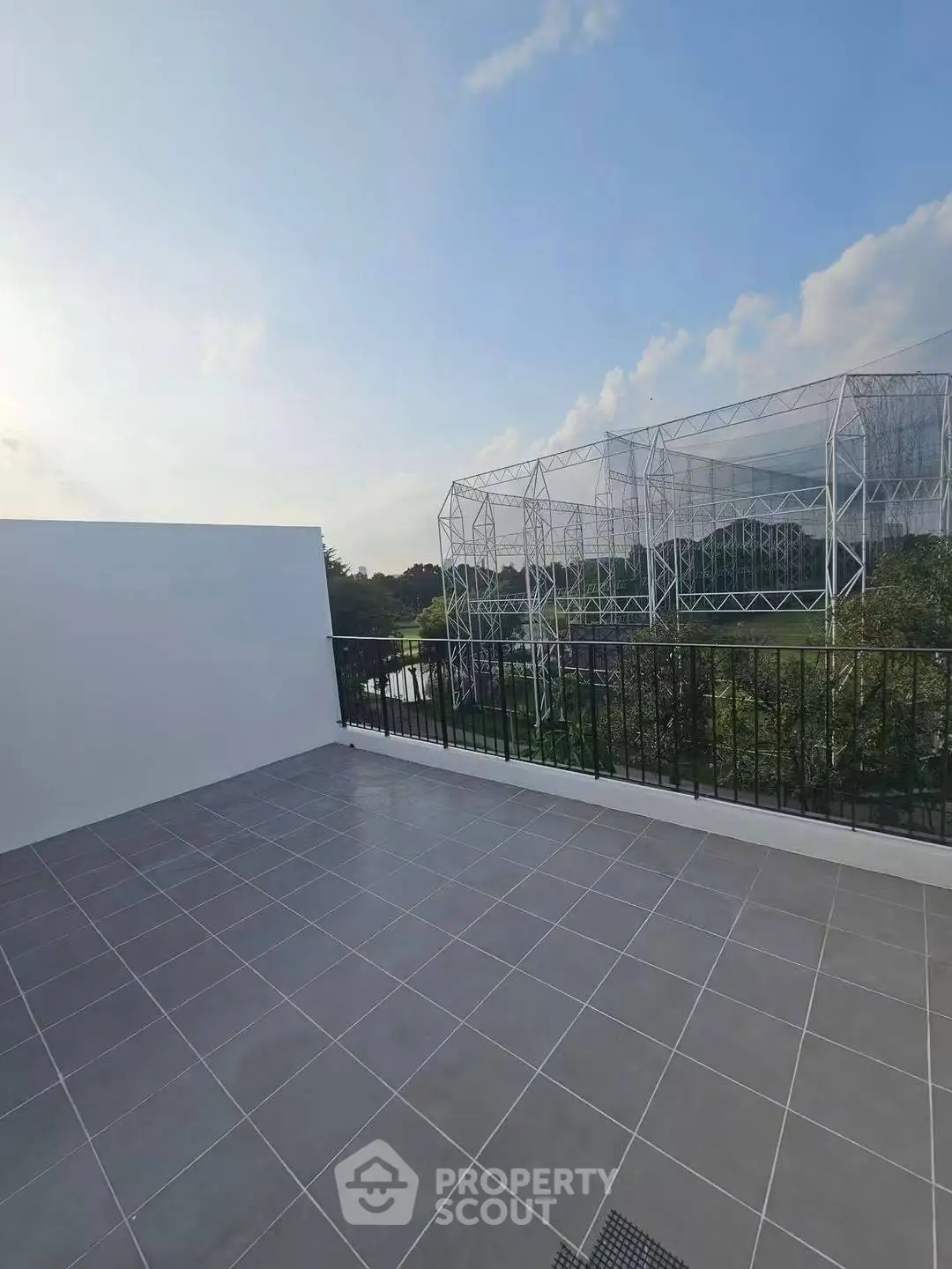 Spacious rooftop terrace with scenic views and modern tile flooring, perfect for outdoor relaxation.