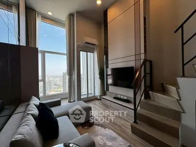Modern living room with city view, stylish furniture, and staircase in high-rise apartment.