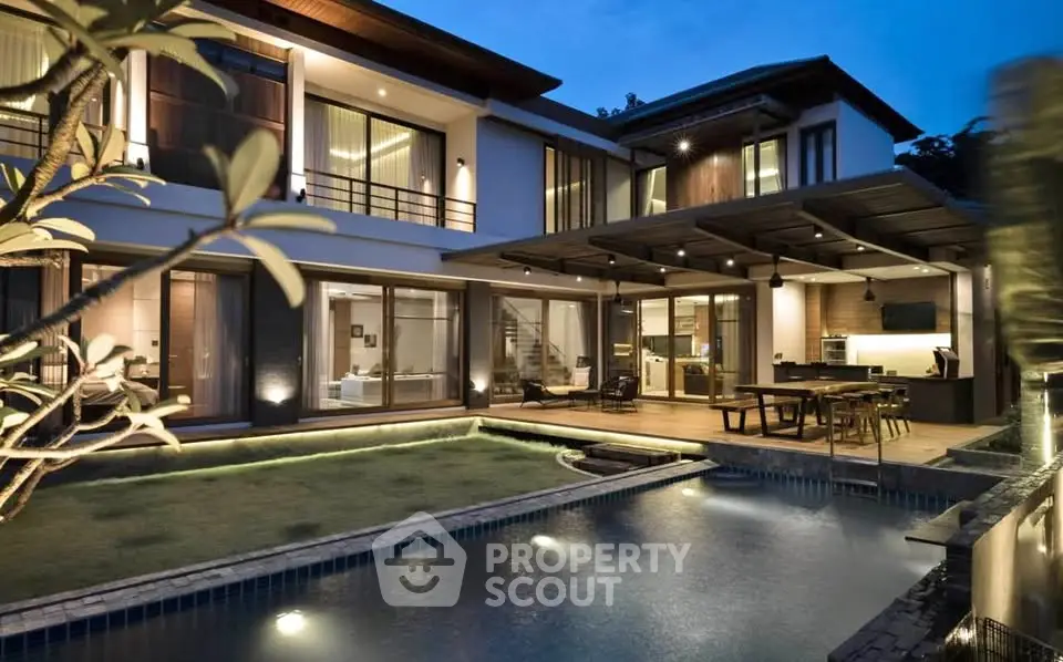 Luxurious modern villa with pool and elegant outdoor lighting at dusk.