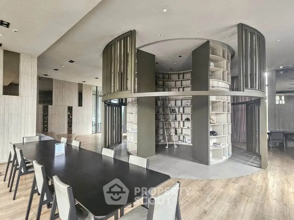 Modern library with circular bookshelf and sleek design in a contemporary building