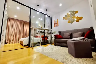 Modern living room with stylish decor and glass partition leading to cozy bedroom.