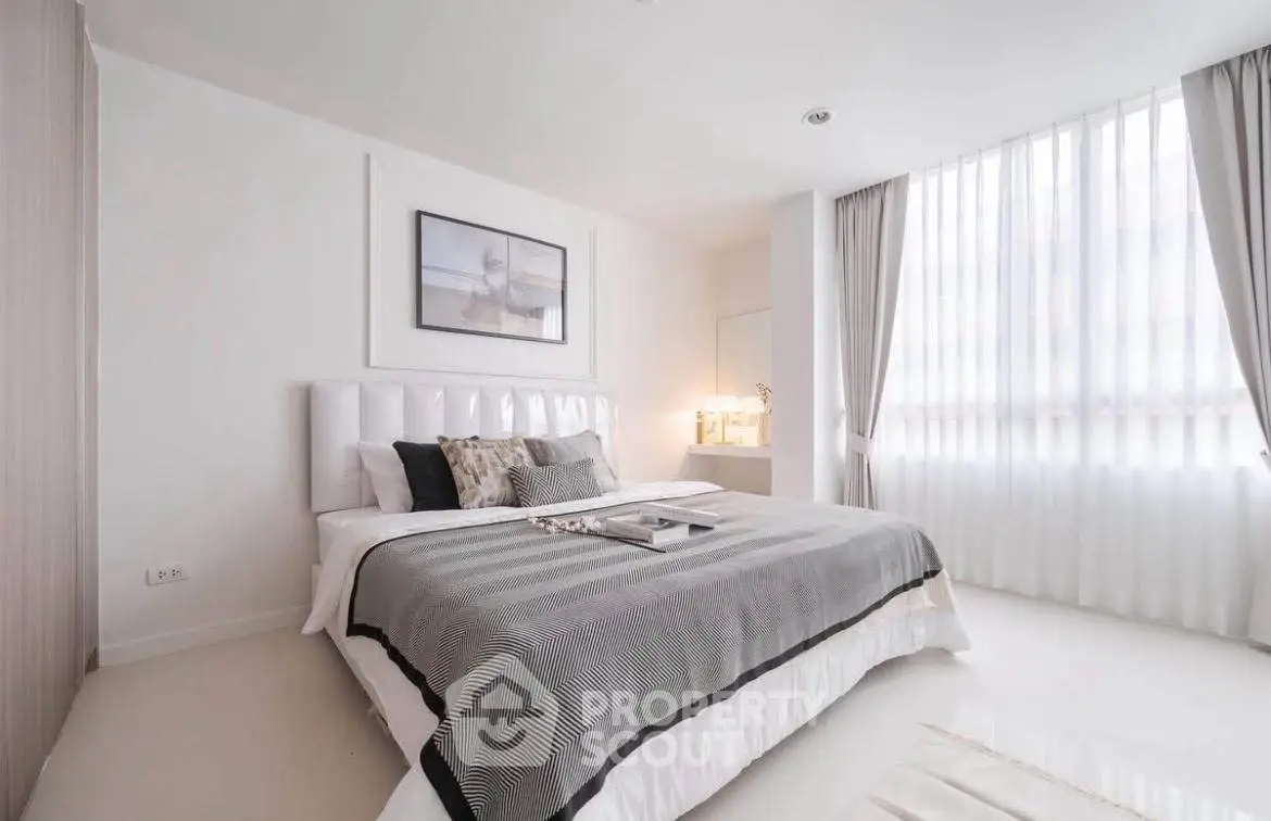 Elegant modern bedroom with large window and stylish decor