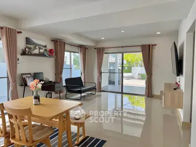 Spacious modern living room with elegant decor and large windows for natural light.
