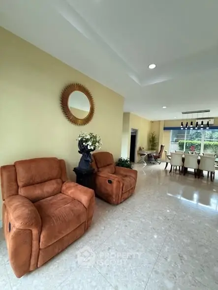 Spacious living room with plush seating and elegant dining area, perfect for entertaining.