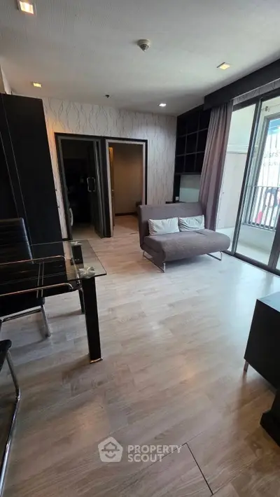 Modern living room with stylish decor and balcony access