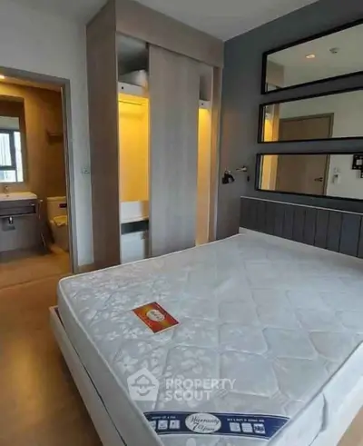 Modern bedroom with stylish wardrobe and comfortable bed in contemporary apartment