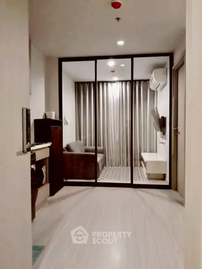 Modern compact living room with glass partition and sleek furnishings