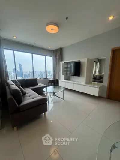 Spacious living room with city view and modern furnishings