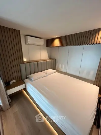 Modern bedroom with sleek design and ambient lighting