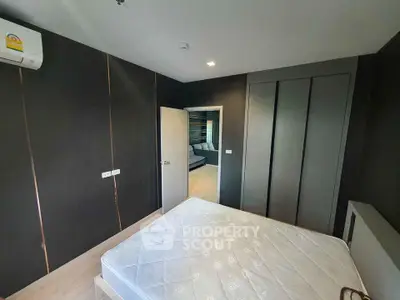 Modern bedroom with sleek design and built-in wardrobe in a stylish apartment.