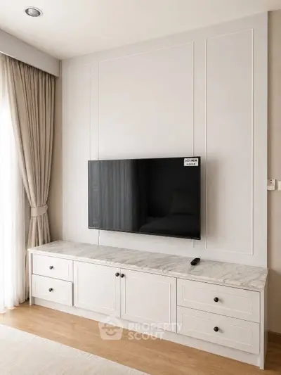 Elegant living room with wall-mounted TV and stylish cabinetry