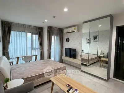 Spacious modern bedroom with large windows and stylish decor in a contemporary apartment.