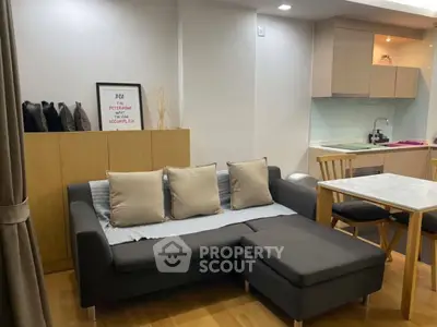Modern living room with stylish sofa and dining area in open layout apartment.
