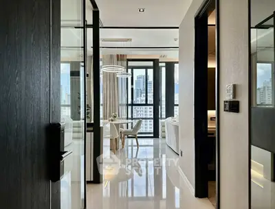 Modern apartment hallway leading to a bright living area with city views.