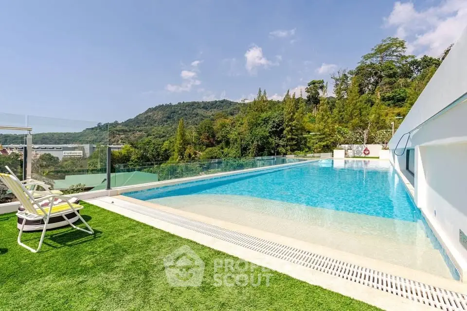 Luxurious rooftop pool with stunning mountain views and lush greenery, perfect for relaxation and leisure.