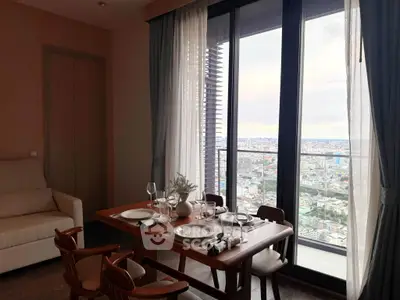Elegant dining area with stunning city view from high-rise balcony