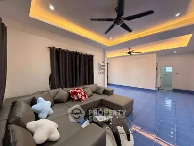 Spacious modern living room with stylish ceiling lights and comfortable sectional sofa.