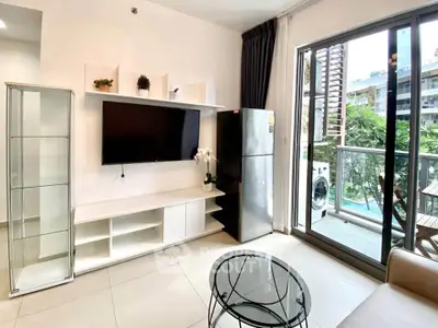 Modern living room with balcony view, sleek furniture, and natural light.