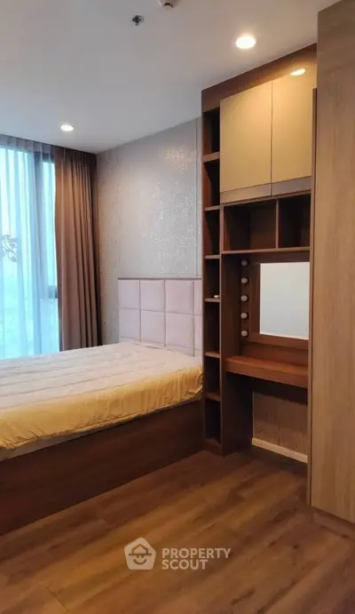 Modern bedroom with elegant wood finishes and built-in vanity mirror