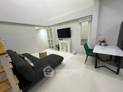 Modern living room with sleek furniture and stylish decor, featuring a cozy sofa and elegant workspace.