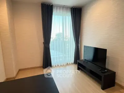 Modern living room with large window and sleek TV setup
