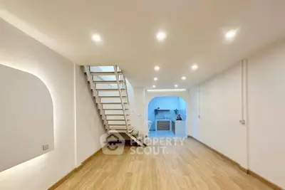 Spacious modern interior with wooden flooring and stylish staircase