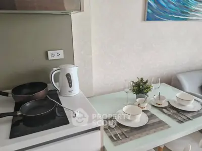 Modern kitchen with dining setup, featuring sleek appliances and stylish decor.