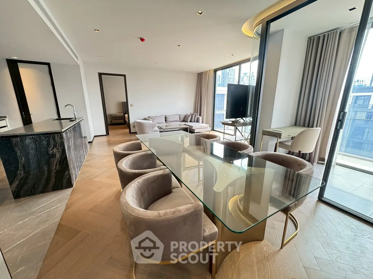Luxurious modern living room with open kitchen and city view, featuring elegant furniture and natural light.