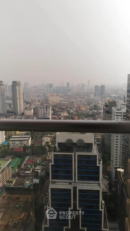 Stunning cityscape view from a high-rise balcony overlooking urban skyline.
