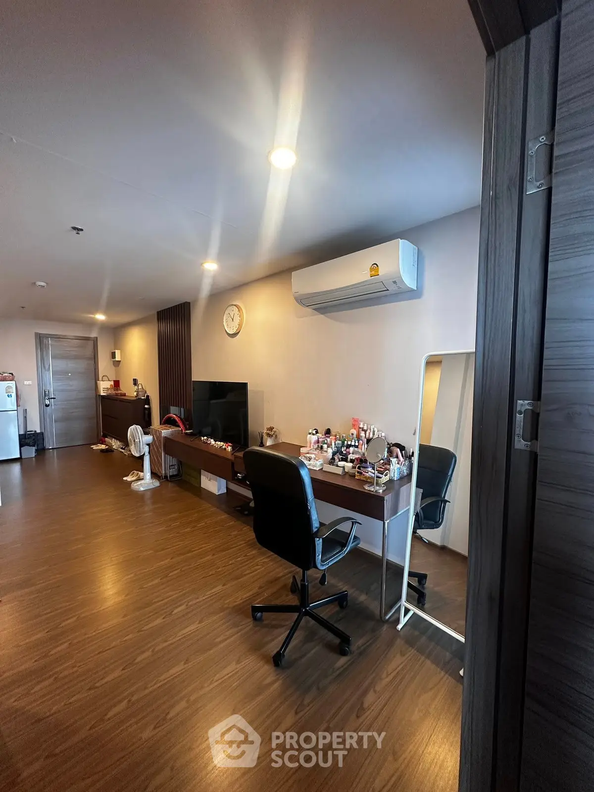 Modern living room with sleek wooden flooring and stylish furniture