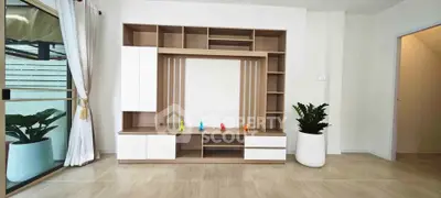 Modern living room with stylish shelving unit and large window view