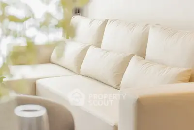 Luxurious cream-colored sofa in a modern living room setting, perfect for relaxation and style.