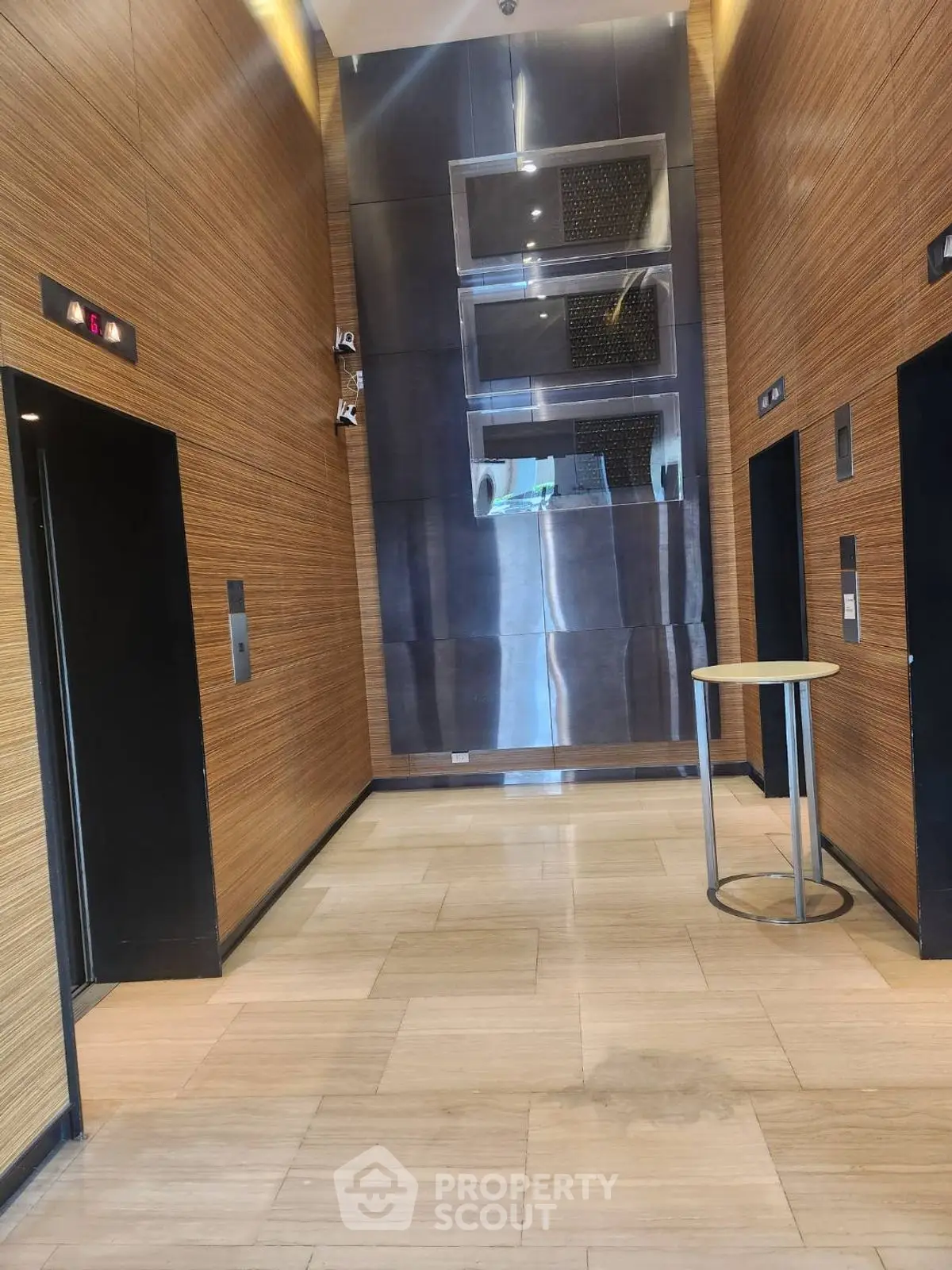 Modern elevator lobby with sleek design and wooden paneling