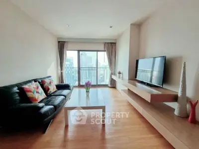 Modern living room with city view, sleek furniture, and natural light.