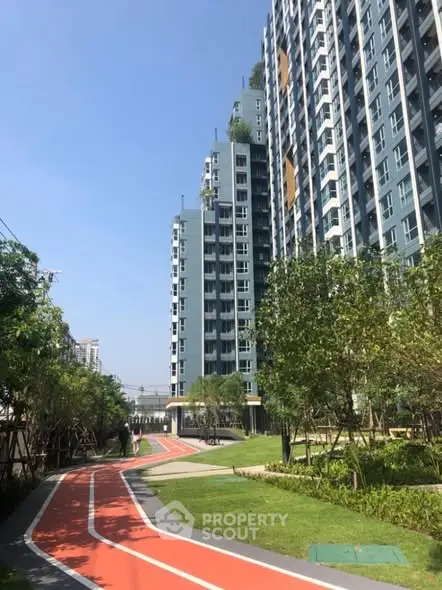 Modern high-rise building with landscaped garden and jogging track