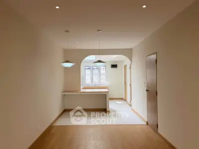 Spacious open-plan living area with natural light and modern fixtures.