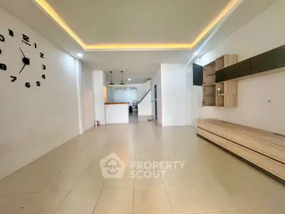 Spacious modern living room with stylish wall clock and sleek storage units