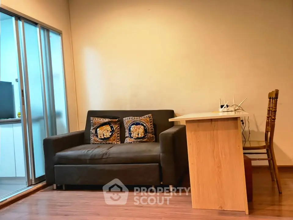 Cozy living room with modern sofa and wooden dining table, perfect for small apartments.