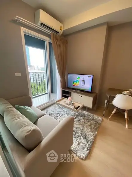 Modern living room with cozy sofa, TV, and city view from window.