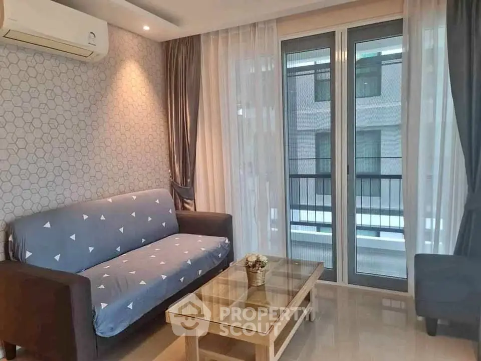 Cozy living room with modern decor and balcony access