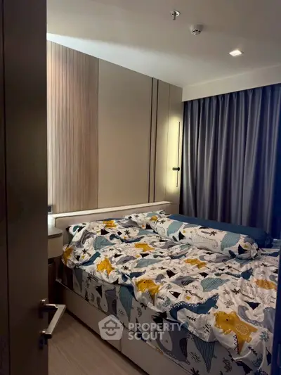 Cozy bedroom with modern decor and stylish bedding in a contemporary apartment.