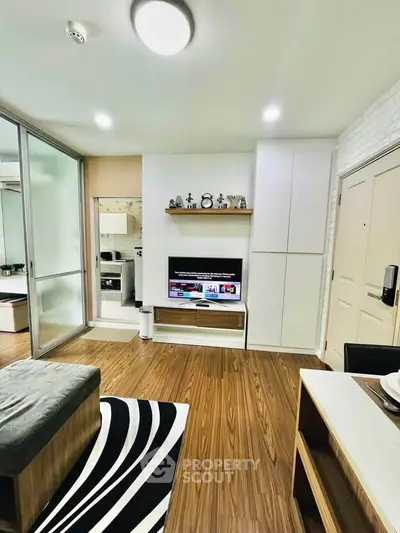 Modern living room with sleek wooden flooring and stylish decor