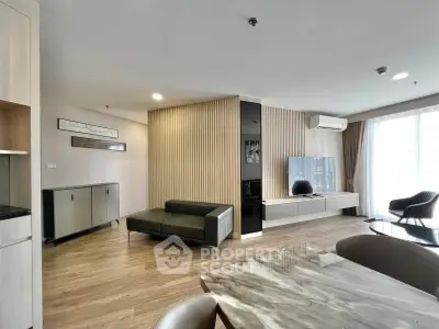 Spacious modern living room with sleek furniture and large windows for natural light.